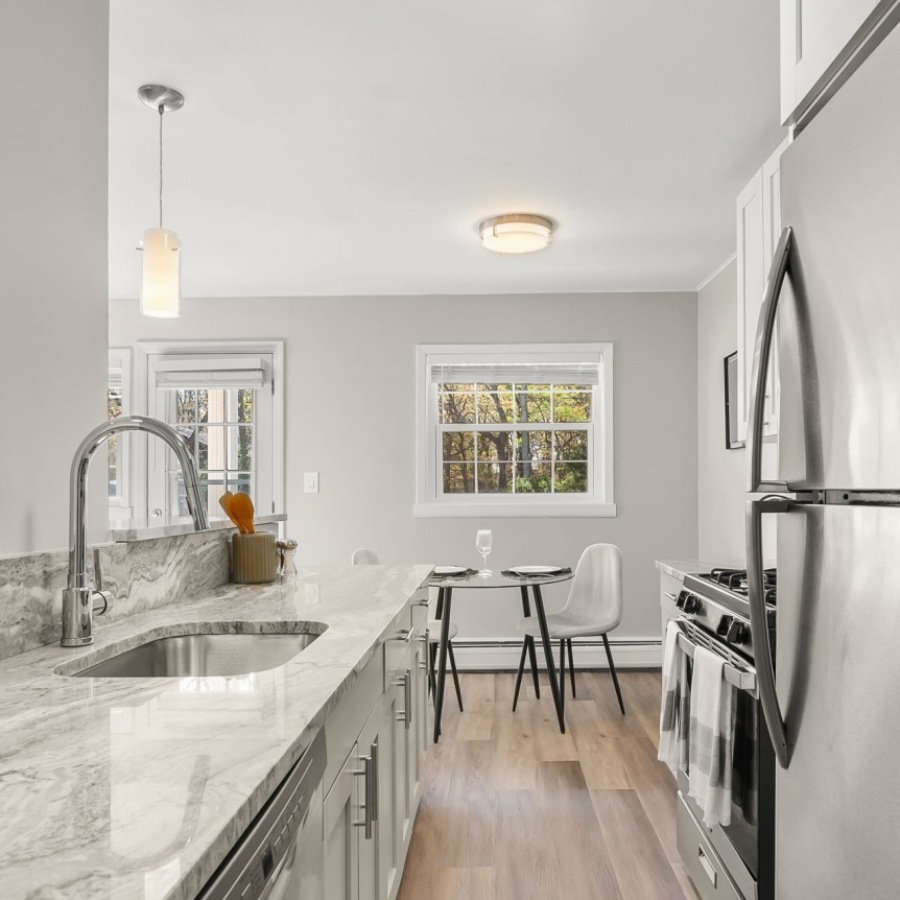 kitchen with ample counter-space, modern appliances and bright lighting